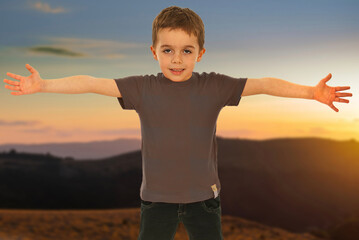 A young boy is pointing at a construction site