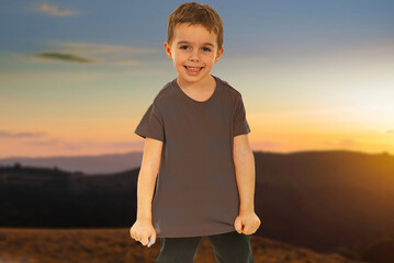 A young boy is pointing at a construction site