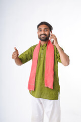 young indian farmer talking on smartphone standing on white background