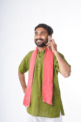 young indian farmer talking on smartphone standing on white background