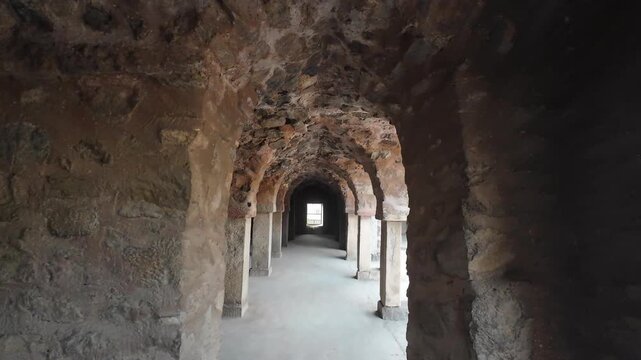 Exploring the Ancient Interior of Firoz Shah Palace Complex Featuring Massive Stone Columns and Symmetrical Arched Passageways in Hisar Haryana India