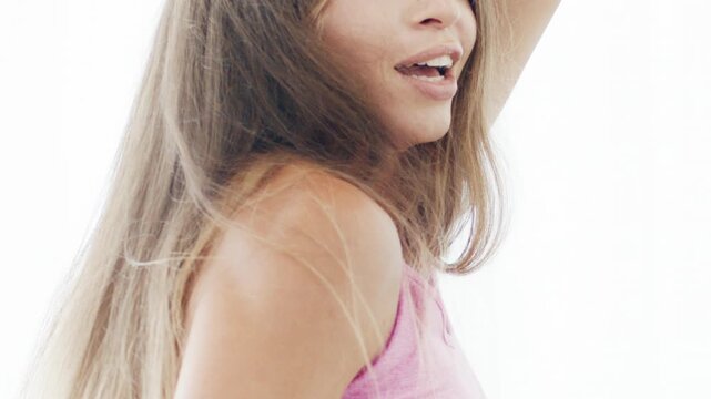 Close up portrait of the young adult woman dancing zumba in the bright airy room