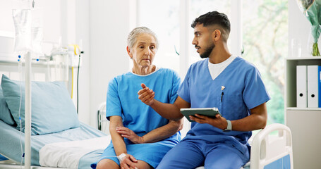 Doctor, old woman and tablet on hospital bed with discussion, explain and feedback for healthcare. People, elderly patient and medical consultation with tech, application and review report at clinic