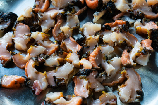 close-up of fresh conch sashimi slices on a dish