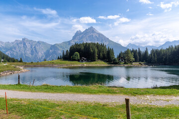 Alpine lake reflecting mountains near Gurtnellen, Uri, Switzerland