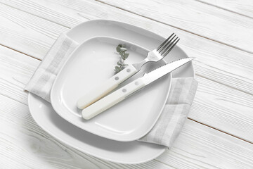 Stylish modern table setting on white wooden background