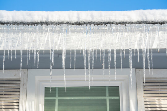 winter house with icicle and snow on the roof