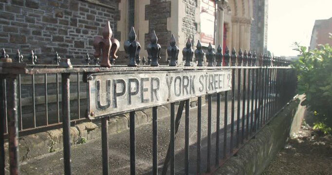 Upper York Street, St Pauls sign on iron railing and church, Bristol, UK