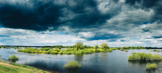 Countryside Landscape During Spring Flood Floodwaters. Bold Bright Blue Sky Above Nature Landscape...