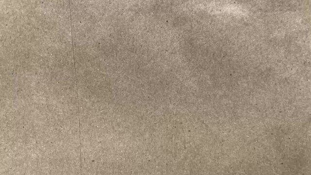 Natural brown paper texture overlay with subtle animated motion and seamless looping. Suitable for vintage, craft, eco, and handmade style projects, as well as creative video backgrounds and overlays.