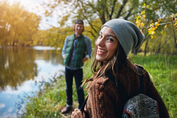 Woman, portrait and couple on hike, forest and adventure with partner in nature, trekking and travel. Outdoor, hikers and people on journey in woods, backpacking and exploration on holiday or trip