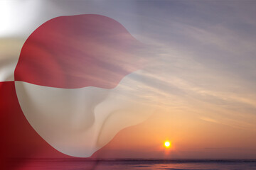 Flag of Greenland against the sunset. National Holidays concept