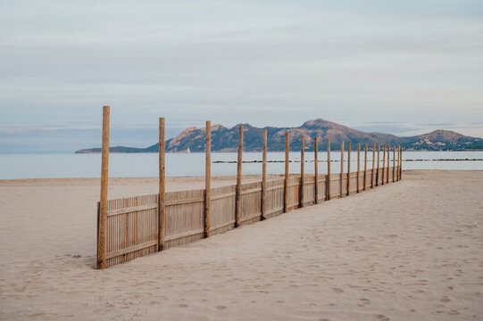 ff season beach windbreaks and calm sea, Port de Pollen&ccedil;a, Mallorca