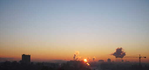 View of the snow-covered skyline of city at sunrise with sky
