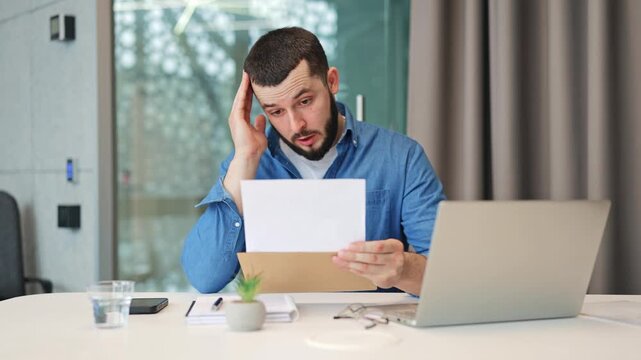Businessperson at office desk reviews document, showing deep worry and concern. Unsettling news evokes distress. Office setting, important communication received.