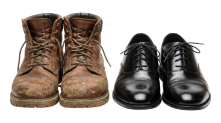 Old dirty brown leather work boots and new polished black oxford dress shoes are placed together illustrating a contrast between lifestyles, manual labor, and formal business