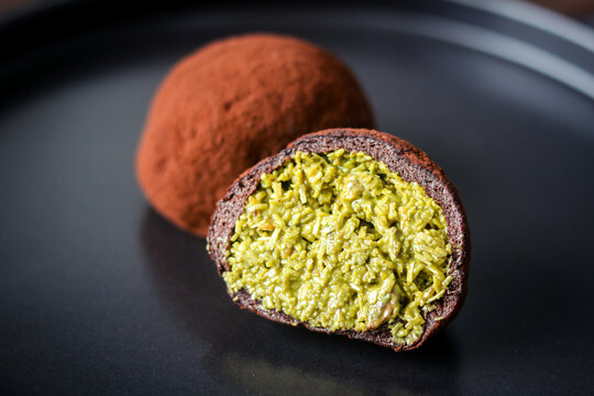 The Dubai Chewy Cookie split open, showing a rich pistachio and kataifi filling.