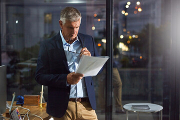 Dark, documents and thinking with business man in glass office for decision, ideas or planning....