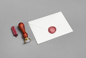 Blank envelope, wax seal and stamp on paper surface. Mockup for placing your design.