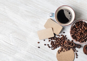 Still life with coffee. Coffee cup, coffee beans, ground powder, beer coaster and blank kraft business cards. .Copy space. Flat lay.