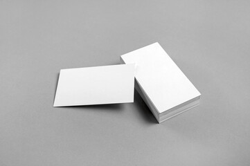 Blank white business cards on paper surface. Template for branding identity. For corporate branding, professional stationery presentation.
