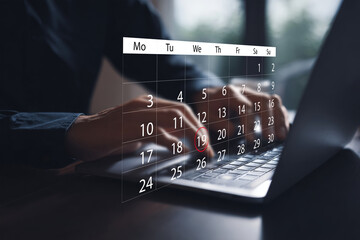 Person interacting with a laptop, featuring a holographic digital calendar overlay highlighting a specific date, symbolizing modern scheduling, event planning