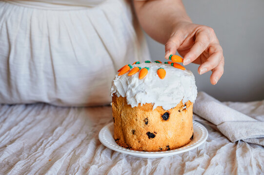 Woman adding final decorations to easter cake.