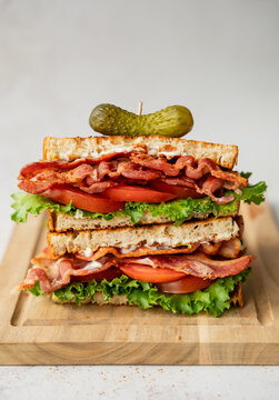 Close up of layers of ingredients in stacked halves of a BLT sandwich.