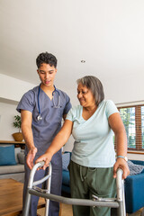 Fototapeta premium African american senior woman, asian healthcare worker guiding walker at home