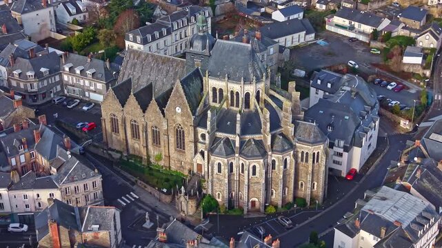 Tilted panning drone fly near the gothic styled and historical Basilica of Our Lady of Miracles of Mayenne or Basilique Notre-Dame-des-Miracles, Mayenne, France