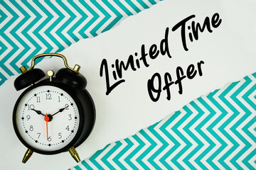 Limited Time Offer text written on paper rip with alarm clock flat lay on turquoise chevron background