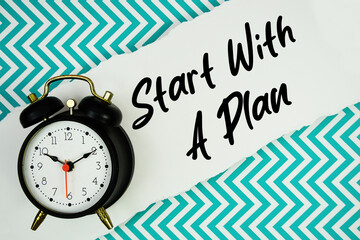 Start With A Plan text written on paper rip with alarm clock flat lay on turquoise chevron background