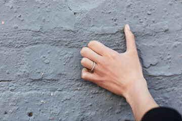 Person, hands and countdown with fingers for engagement, anniversary or save the date on brick wall. Closeup, marriage and counting with commitment, symbol or gesture for event, time or plan on space