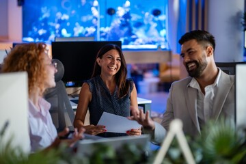 Happy multicultural business team sharing ideas at modern office