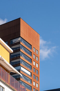 modern architecture building facade of residential apartment in urban liljeholmskajen stockholm with skyline backdrop for real estate promotion