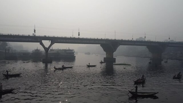 Low Altitude Drone Flight Toward Silhouetted Wooden Boats in Heavy Smog on Buriganga River