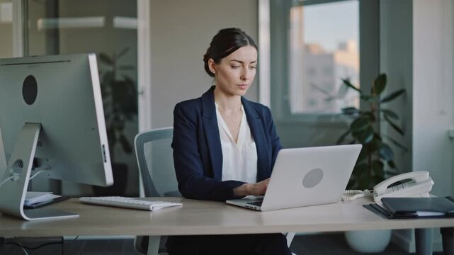 young businesswoman working and typing on her laptop