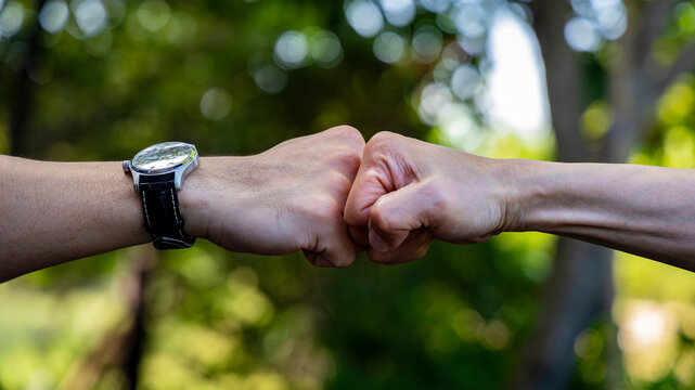 Deal of teamwork with the Man hand a fist bump commit as get together in the office	