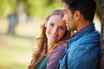 Fototapeta premium Love, hug and happy with couple in park for romance, marriage and smile together. Summer, honeymoon and relationship with man and portrait of woman in nature for support, connection and space