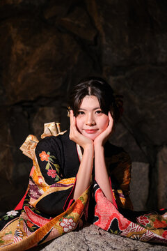 Woman in furisode kimono celebrating Seijin no Hi at night