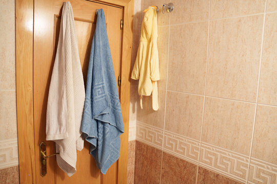 Warm bathroom with neat towels, Homely bath featuring hanging towels and cozy atmosphere