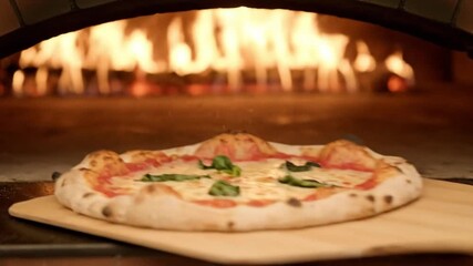 A close-up shot highlights a delicious, freshly baked pizza, likely a classic Neapolitan style, resting on a wooden pizza peel. The pizza boasts a perfectly golden, slightly charred crust with a puffy