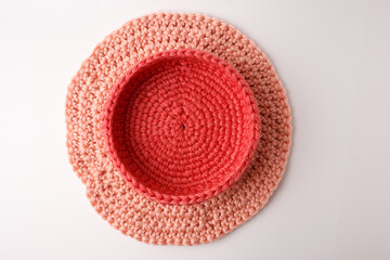 Assembly process of handmade crochet easter basket. Top view of inner bowl on outer ring base. Ideal for diy craft blog, creative tutorial book, knitting workshop, hobby store marketing content.