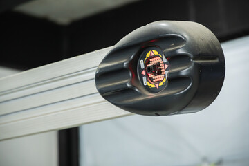 Close-up of 3D wheel alignment machine camera sensor with red LED lights on metal beam in auto repair garage, Auto repair shop Garage, Wheel alignment service, Vehicle inspection