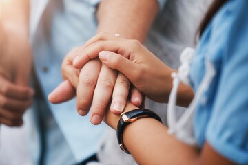 Closeup of two people holding hands, one adult and one child, showing connection and support