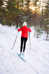 Woman skiing in  winter forest