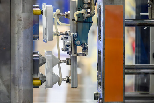 Close Up of Plastic Injection Molding Machine with Robotic Automation System