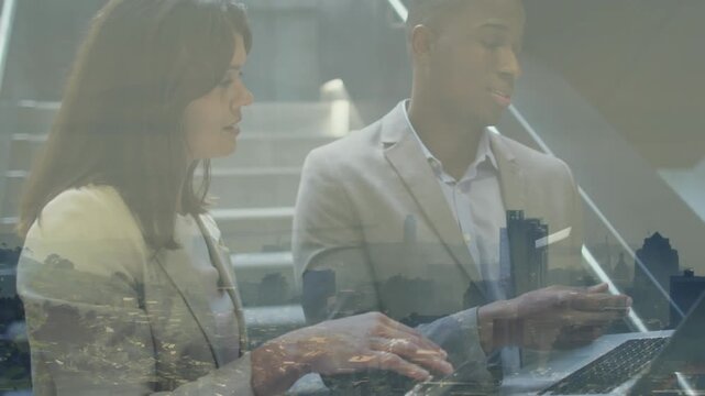 Animation of businesswomen using laptop at unk over businesswomen using businesswomen unk