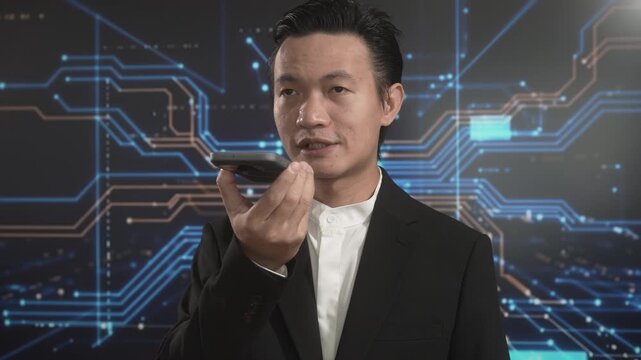 Asian businessman speaking into smartphone for voice command against futuristic digital circuit background, symbolizing artificial intelligence, smart technology, digital assistant usage