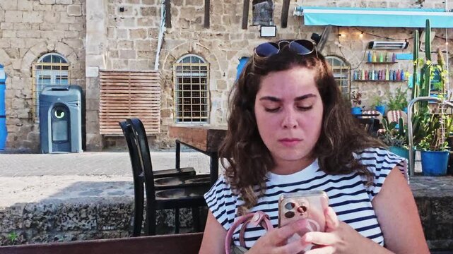 Relaxed Tourist Girl Using Phone App In Jaffa Port Area